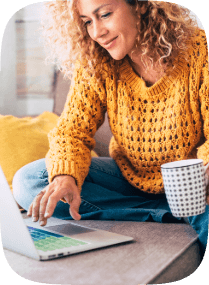 Picture of a woman on the laptop with a coffee